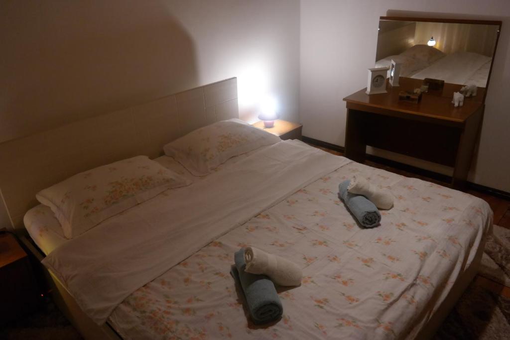 a bedroom with a bed with shoes on it at Gorski cvijet in Delnice
