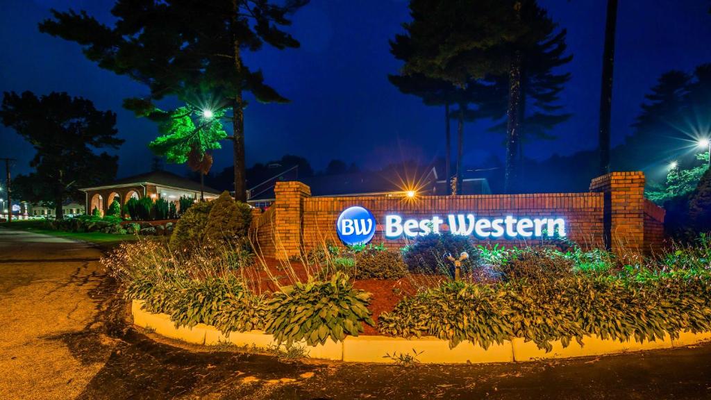 a sign that reads best western at night at Best Western West Greenwich Inn in West Greenwich