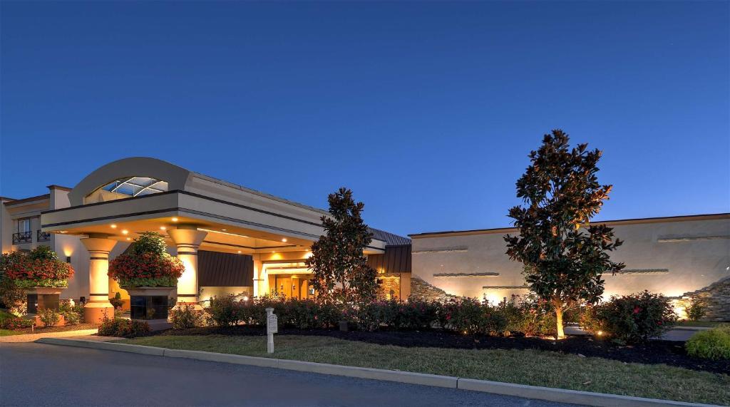 a large building with a lit up facade at night at Eden Resort and Suites, BW Premier Collection in Lancaster