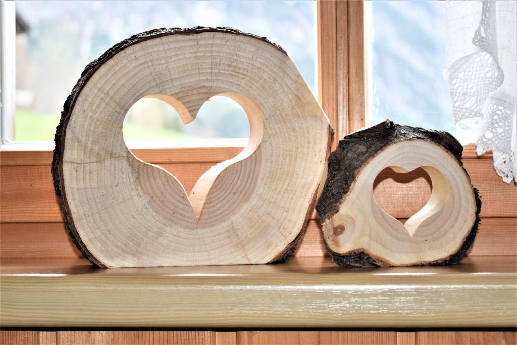 a couple of hearts carved out of a window at Haus Grassa in Brand