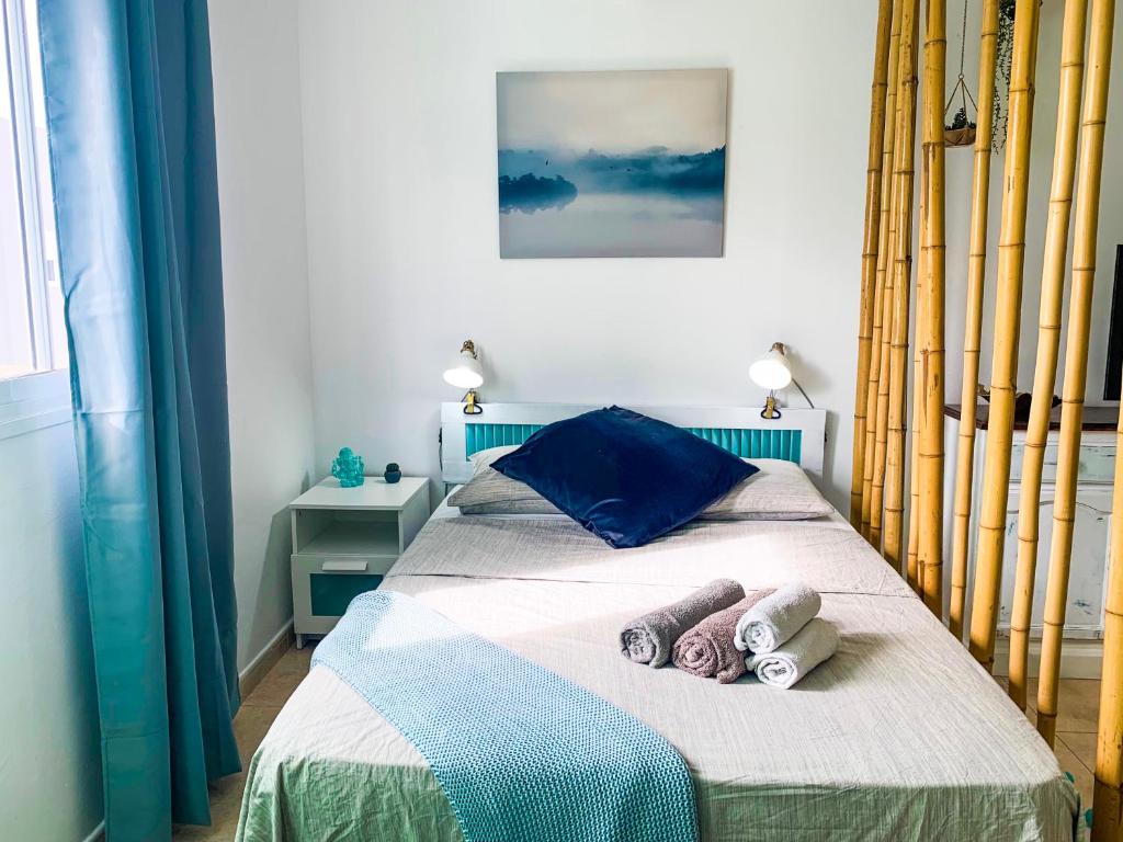 a bedroom with a bed with towels on it at Hibiscus Studio in Corralejo