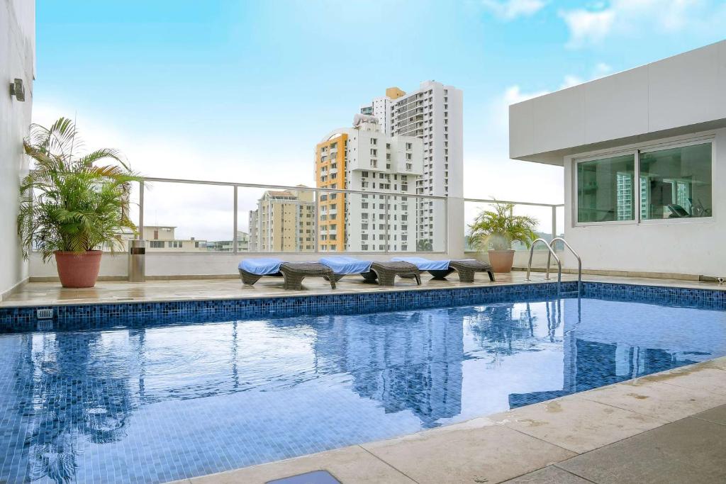 a swimming pool on the roof of a building at Ramada by Wyndham Panama Via Argentina in Panama City