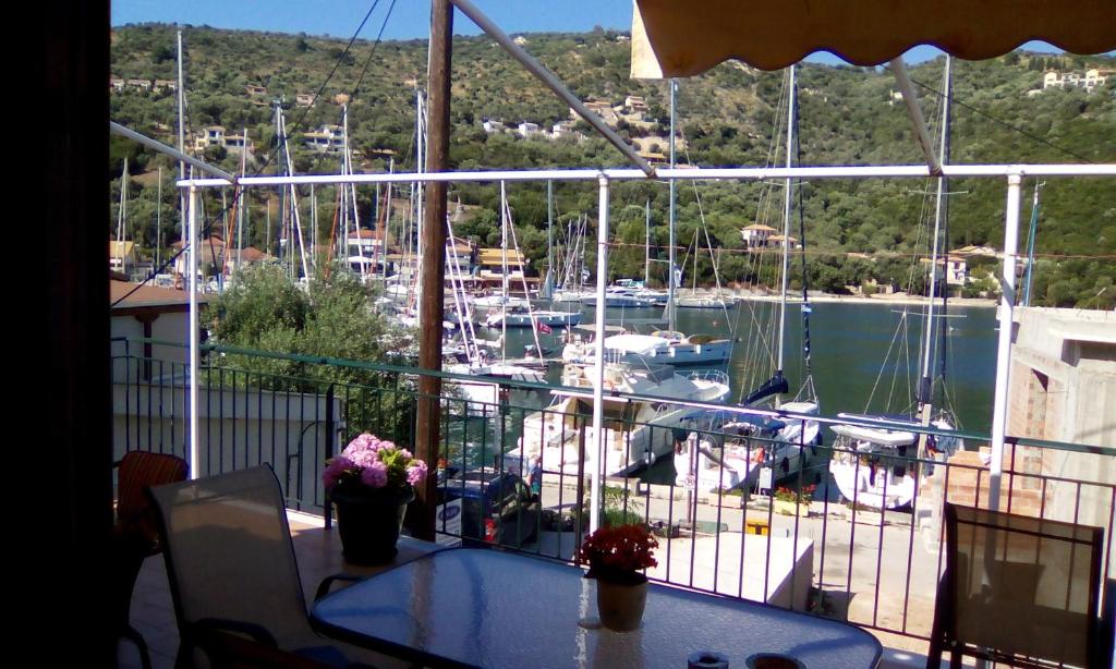 a balcony with a view of a marina with boats at Aristoula House in Sivota