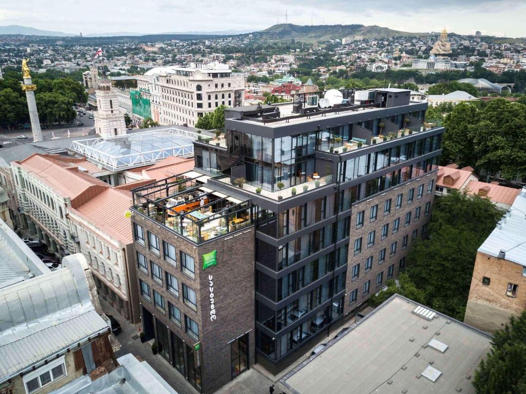 a large building with a large clock on it at ibis Styles Tbilisi Center in Tbilisi City