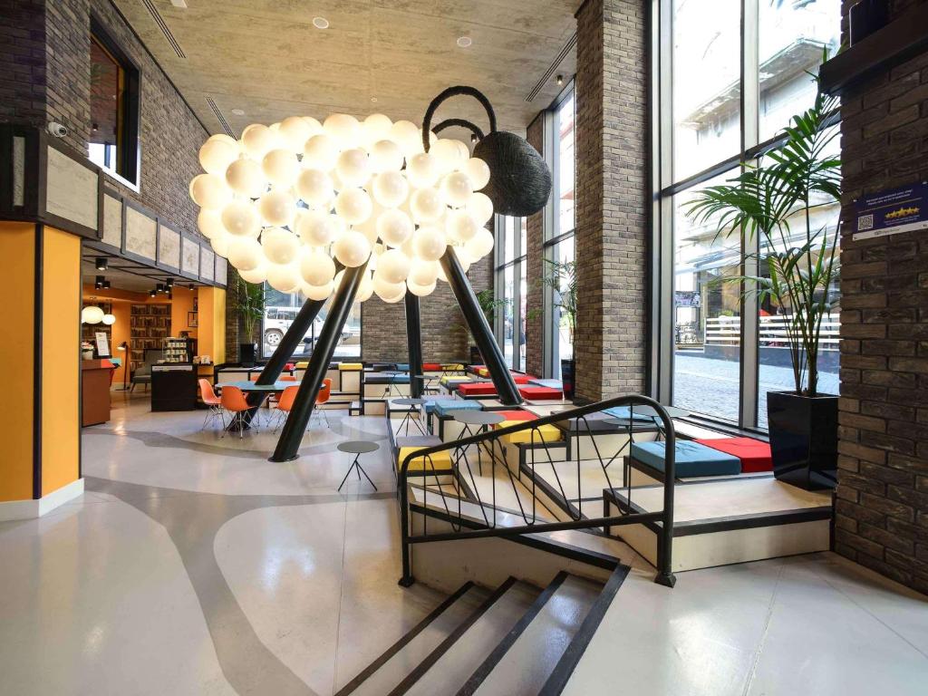 a lobby with a bunch of lights in a building at ibis Styles Tbilisi Center in Tbilisi City