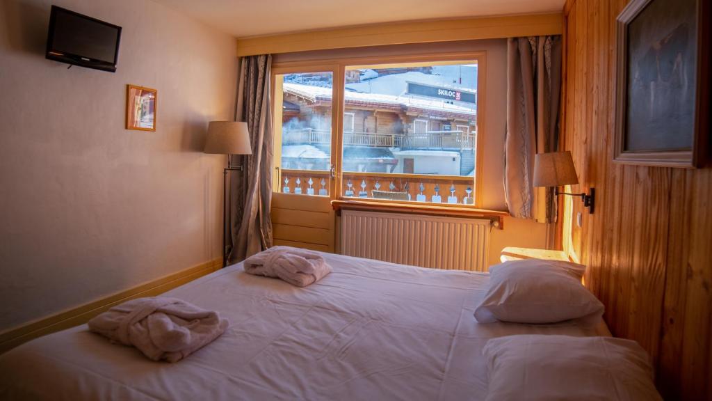Postel nebo postele na pokoji v ubytování Hôtel Arbois Bettex