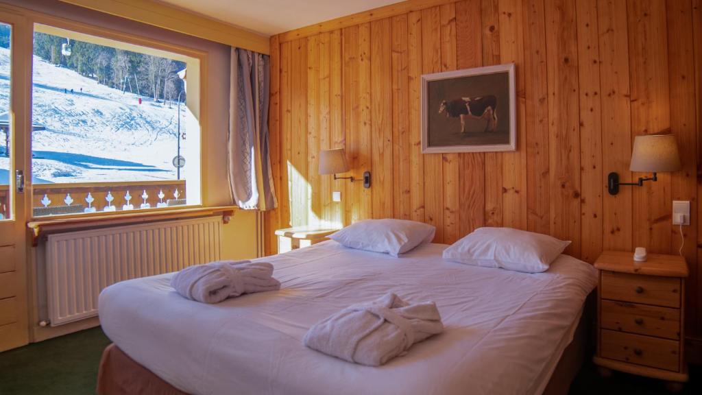 Postel nebo postele na pokoji v ubytování Hôtel Arbois Bettex