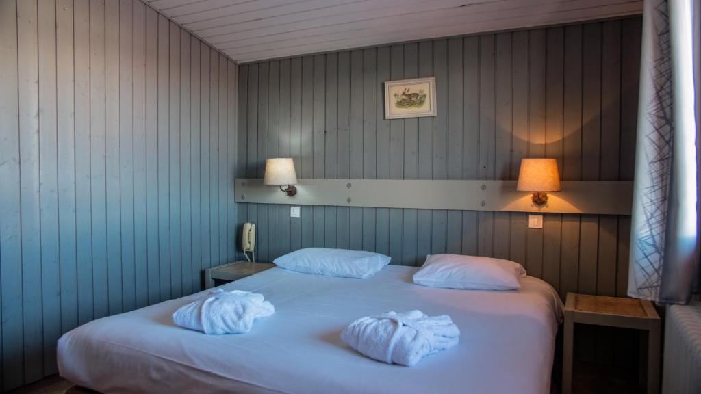 Postel nebo postele na pokoji v ubytování Hôtel Arbois Bettex