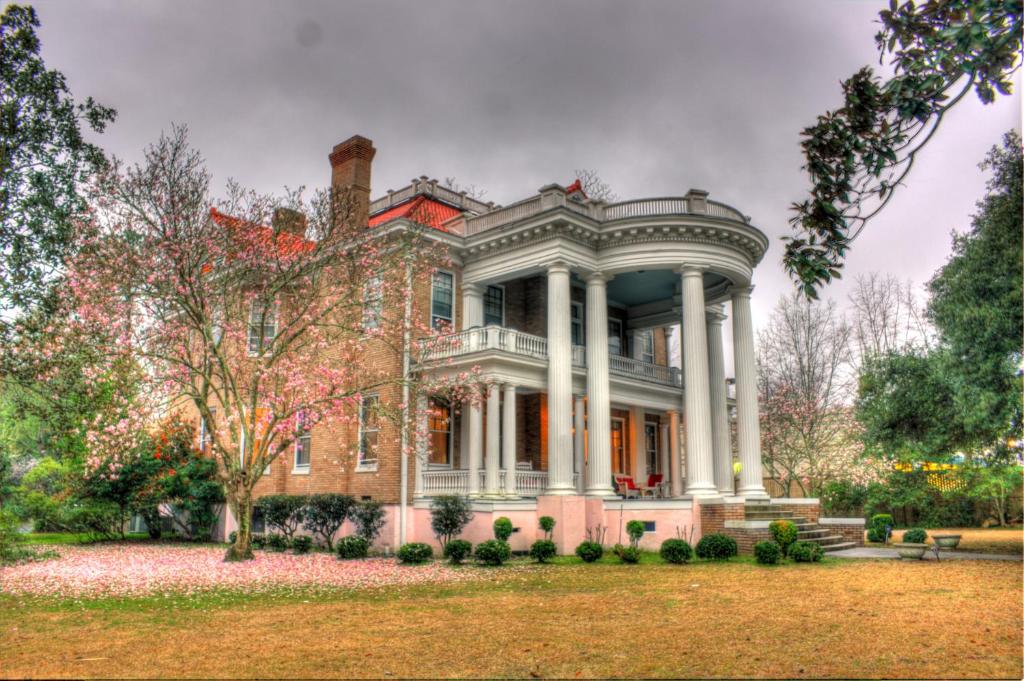 a large brick house with a porch at 1912 Bed and Breakfast in Sumter
