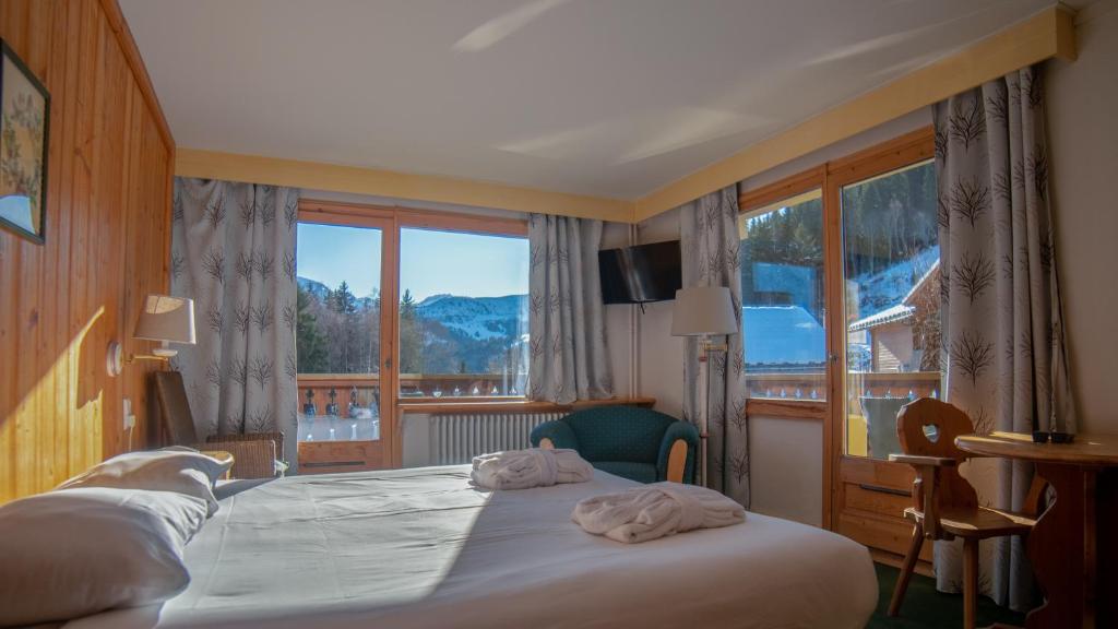 Postel nebo postele na pokoji v ubytování Hôtel Arbois Bettex