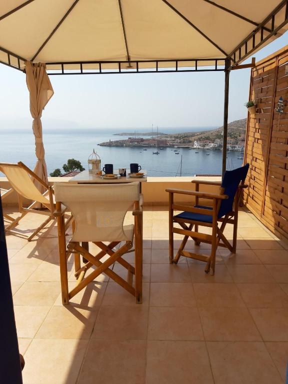 a dining room with a view of the ocean at Marina Castellana Studios in Halki