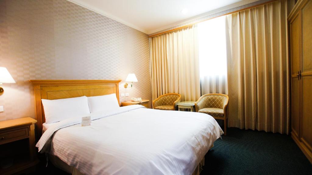 Postel nebo postele na pokoji v ubytování Cambridge Hotel - Yung Kang