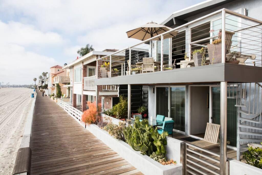 a building on the beach with a wooden boardwalk at Oceanfront Oasis in Long Beach