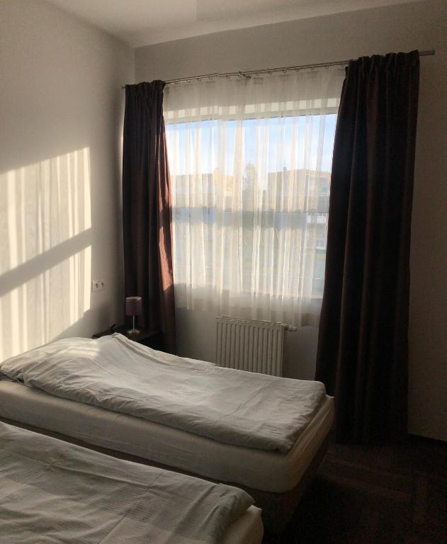 Postel nebo postele na pokoji v ubytování Hipodrom Sopot