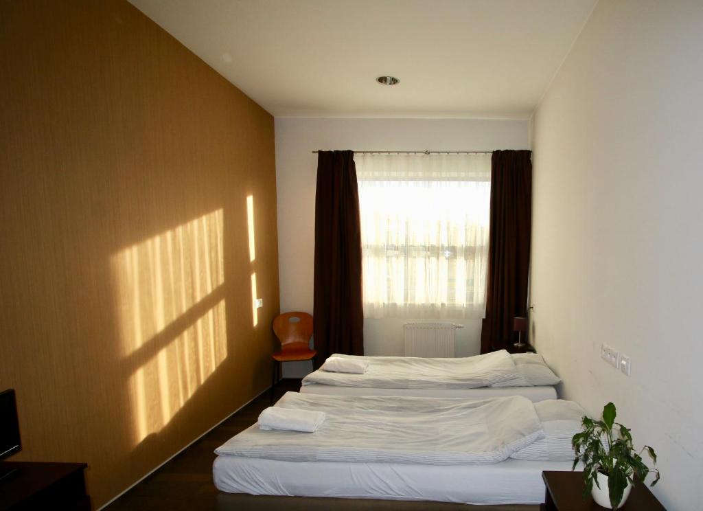 Postel nebo postele na pokoji v ubytování Hipodrom Sopot