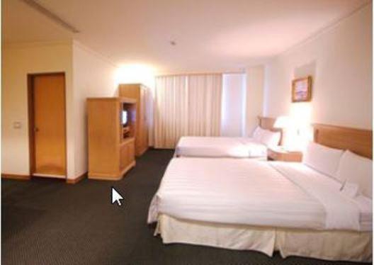 Postel nebo postele na pokoji v ubytování Cambridge Hotel - Yung Kang