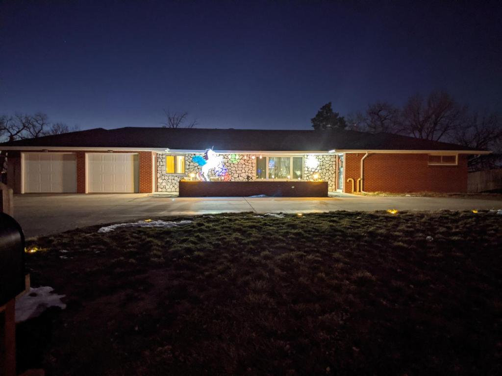 a house with christmas lights on the front of it at DIA BnB - Mountain View - Private floor - DIA Layover - Great entertainment and bed in Brighton