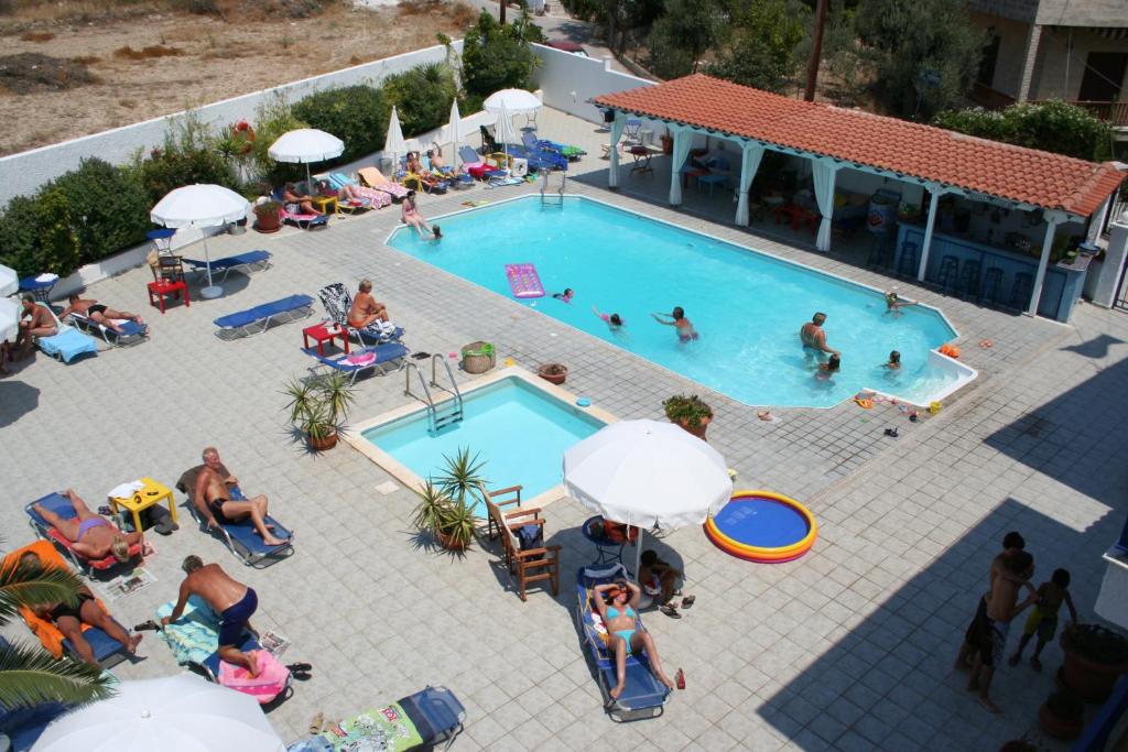 an overhead view of a swimming pool with people in it at Helios Hotel in Agia Marina Aegina