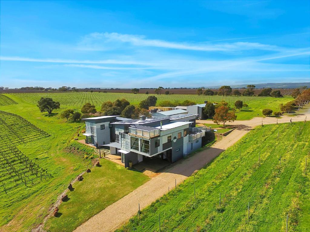 an aerial view of a house in the middle of a field at Hotel California Road at Inkwell Wines in McLaren Vale