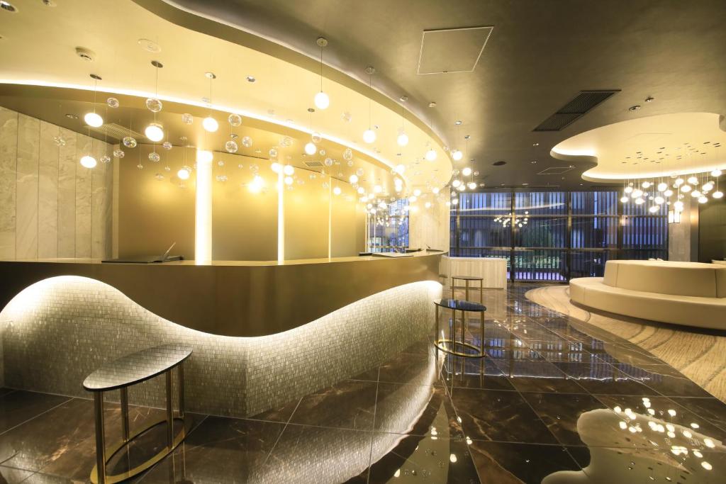 a lobby with chairs and a bar with lights at Quintessa Hotel Tokyo Ginza in Tokyo