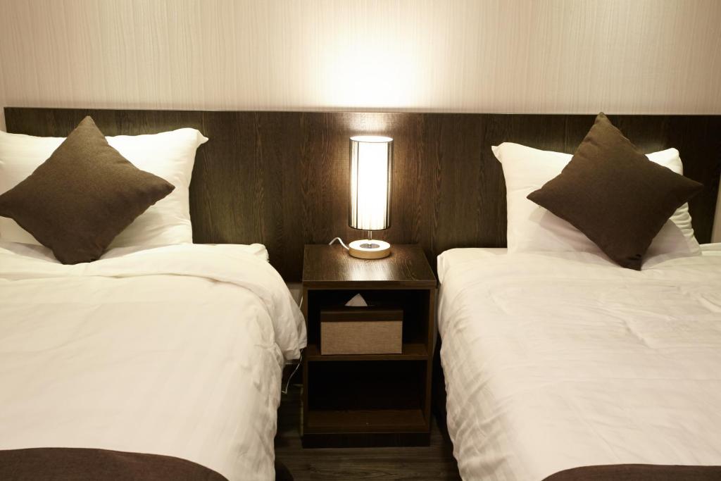 Postel nebo postele na pokoji v ubytování CS Premier Hotel
