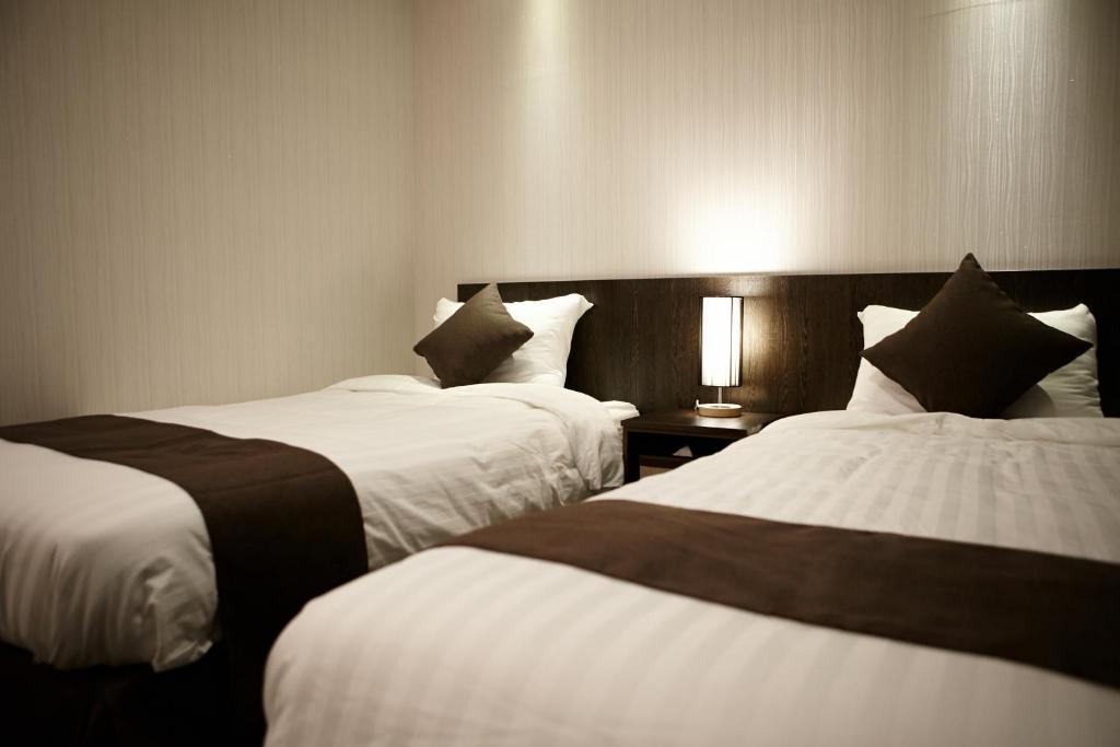 Postel nebo postele na pokoji v ubytování CS Premier Hotel