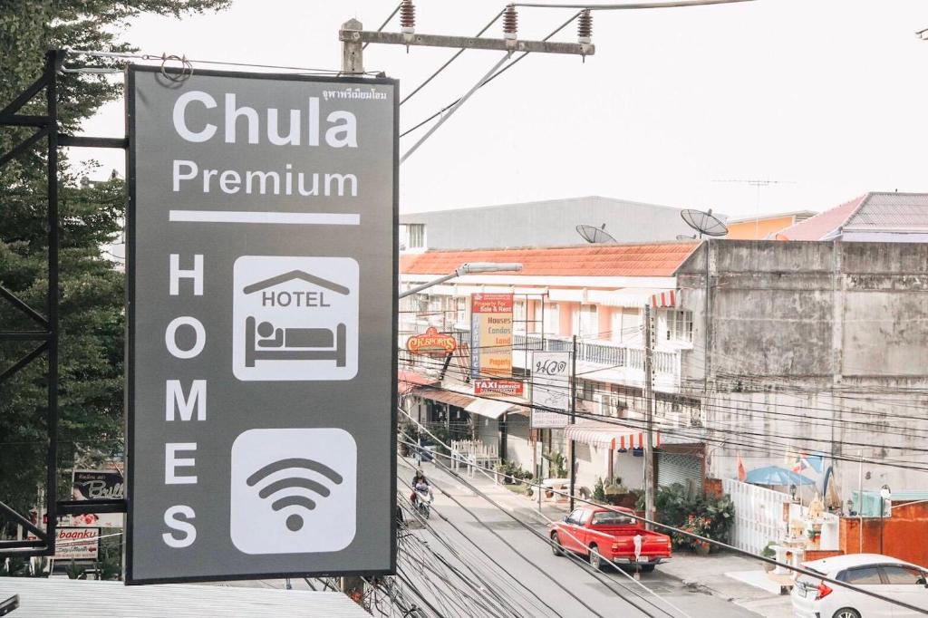 a sign for a hotel on the side of a street at Chula Premium Homes in Ban Chang