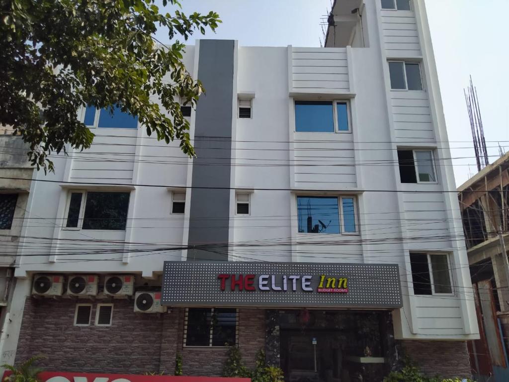 a white building with a sign for the elite inn at THE ELITE INN in Visakhapatnam