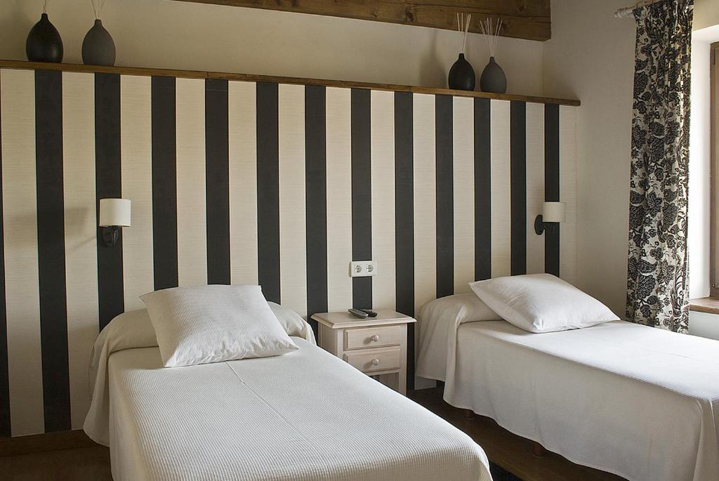 A bed or beds in a room at Posada Ruilobuca