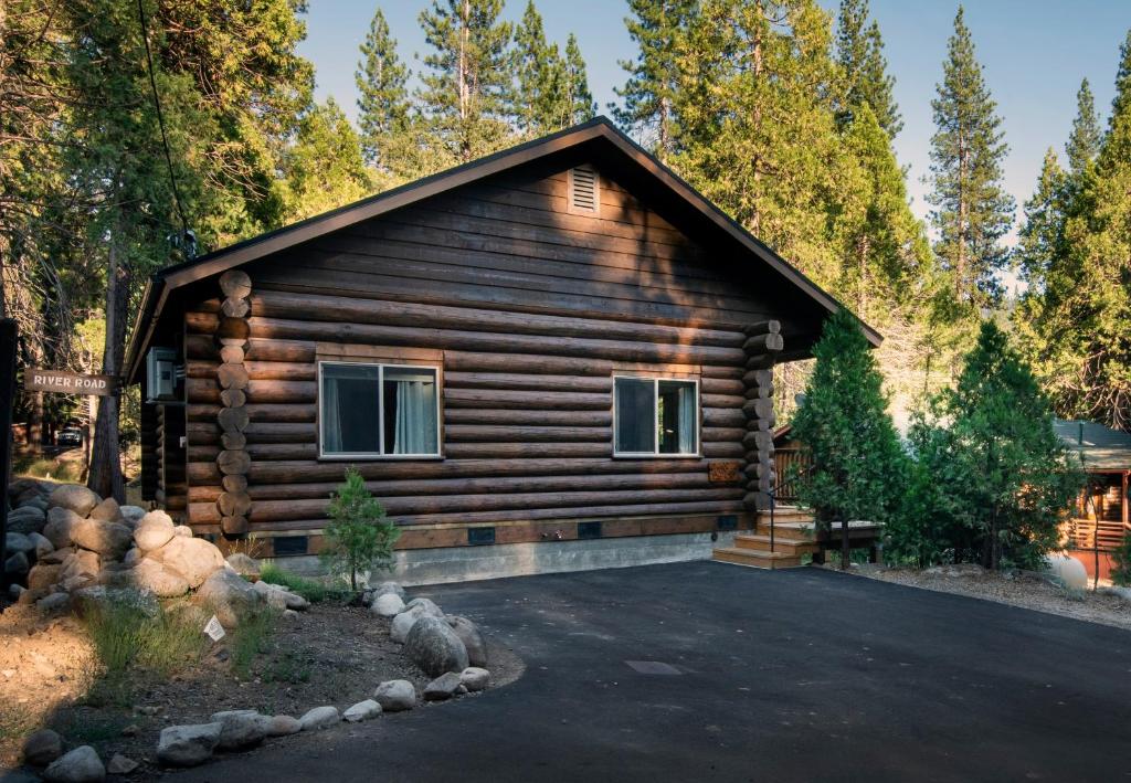 a log cabin with a driveway in front of it at 38 The Mini Cabin in Wawona