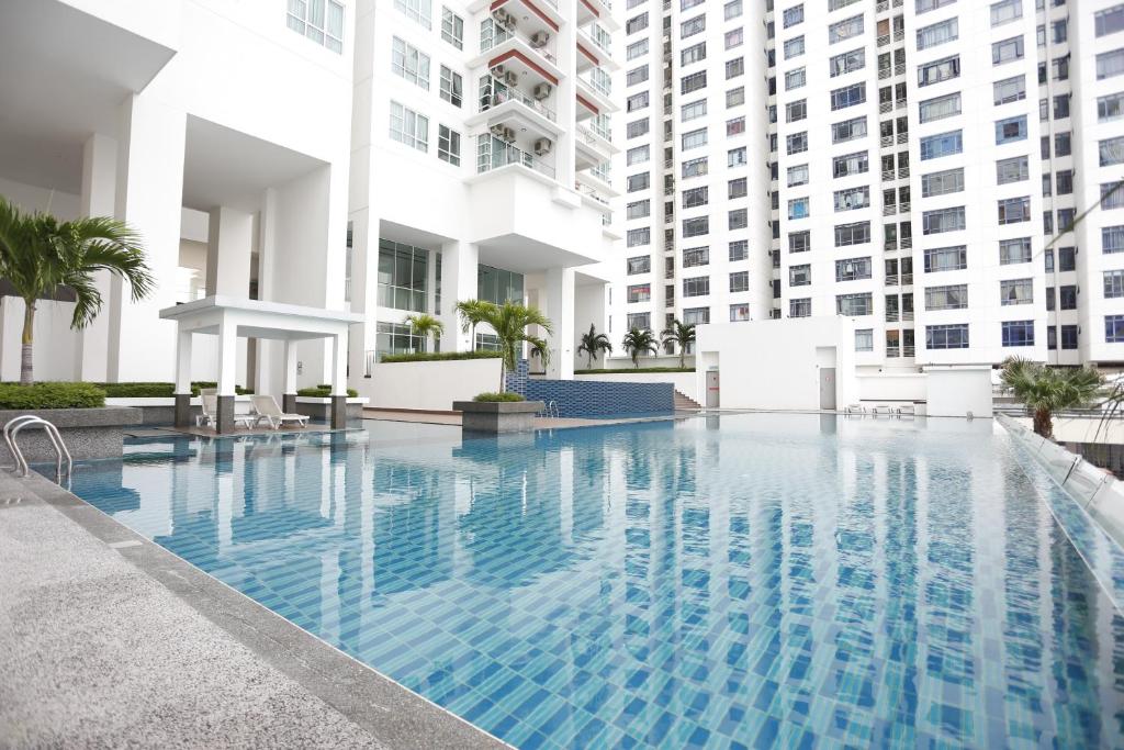 a swimming pool in a building with tall buildings at Pinnacle Tower Homestay by Home Cube in Johor Bahru
