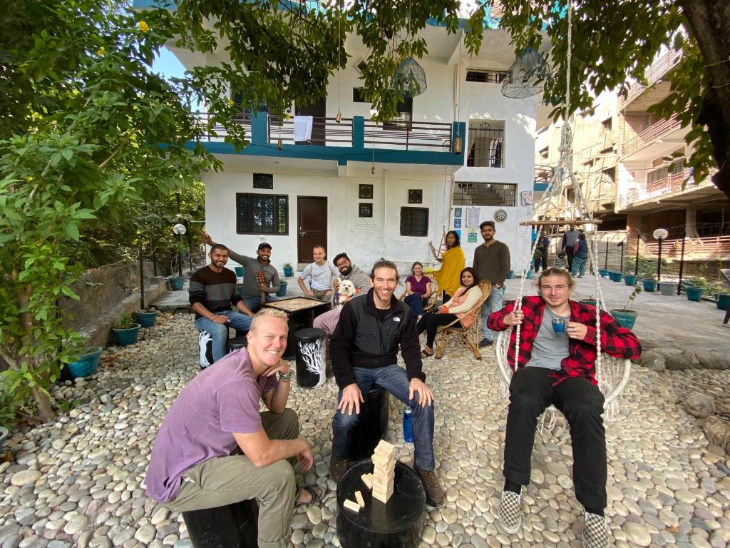 a group of people sitting in front of a house at Soul Haven in Rishīkesh