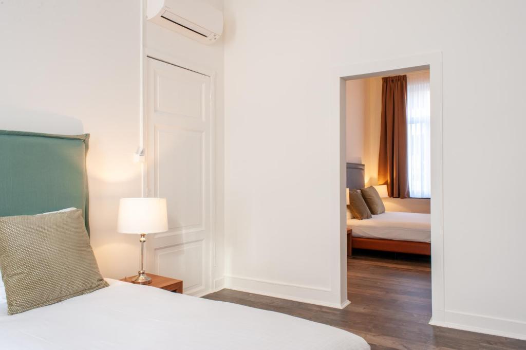 Postel nebo postele na pokoji v ubytování La Lys Rooms & Suites