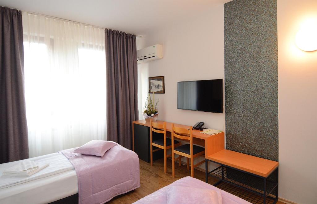 Postel nebo postele na pokoji v ubytování Zepter Hotel Drina Bajina Basta, member of Zepter Hotels