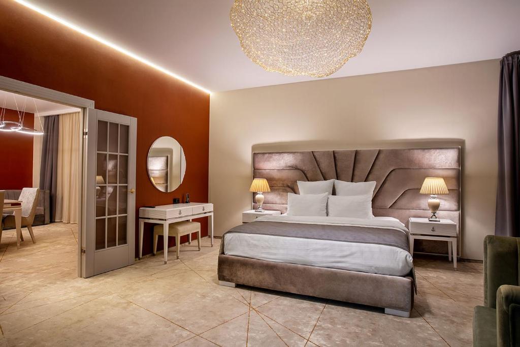 a hotel room with a bed and a desk and a bedroom at Barin Residence Grand in Moscow