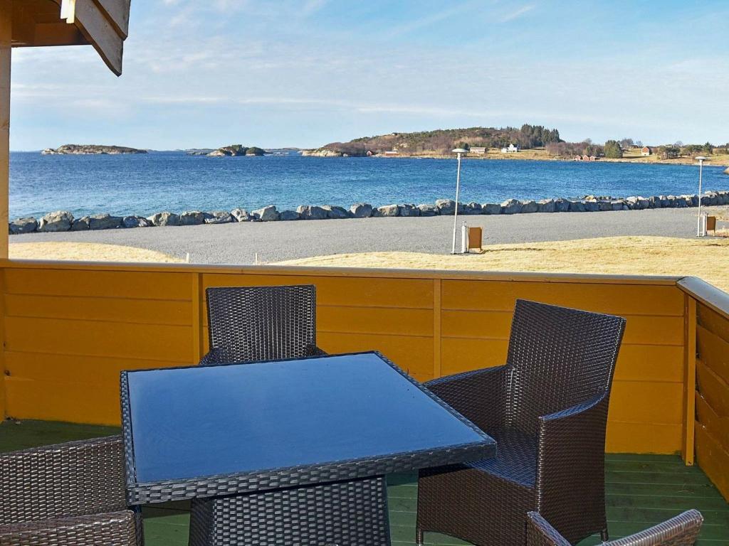 una mesa y sillas con vistas a la playa en Holiday home Aukra IV, en Aukra