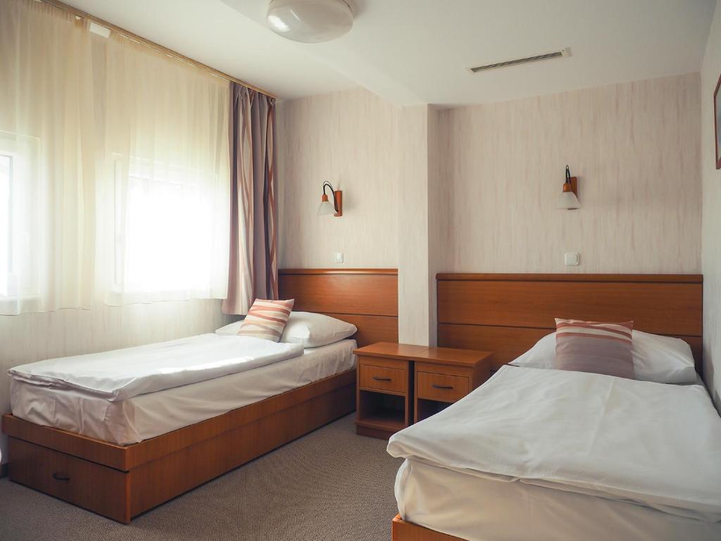 Postel nebo postele na pokoji v ubytování Hotel Panoráma