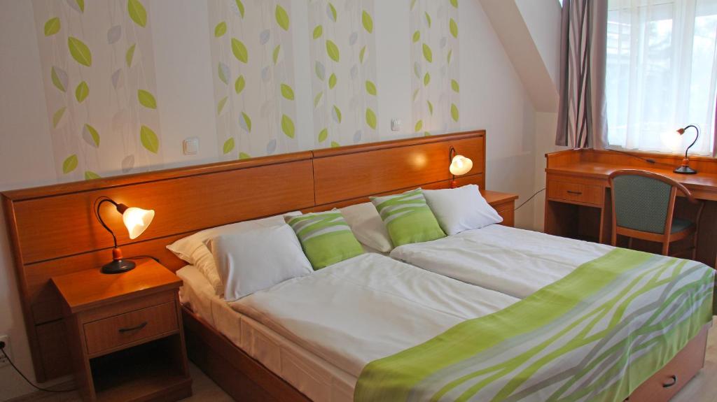 Postel nebo postele na pokoji v ubytování Hotel Panoráma