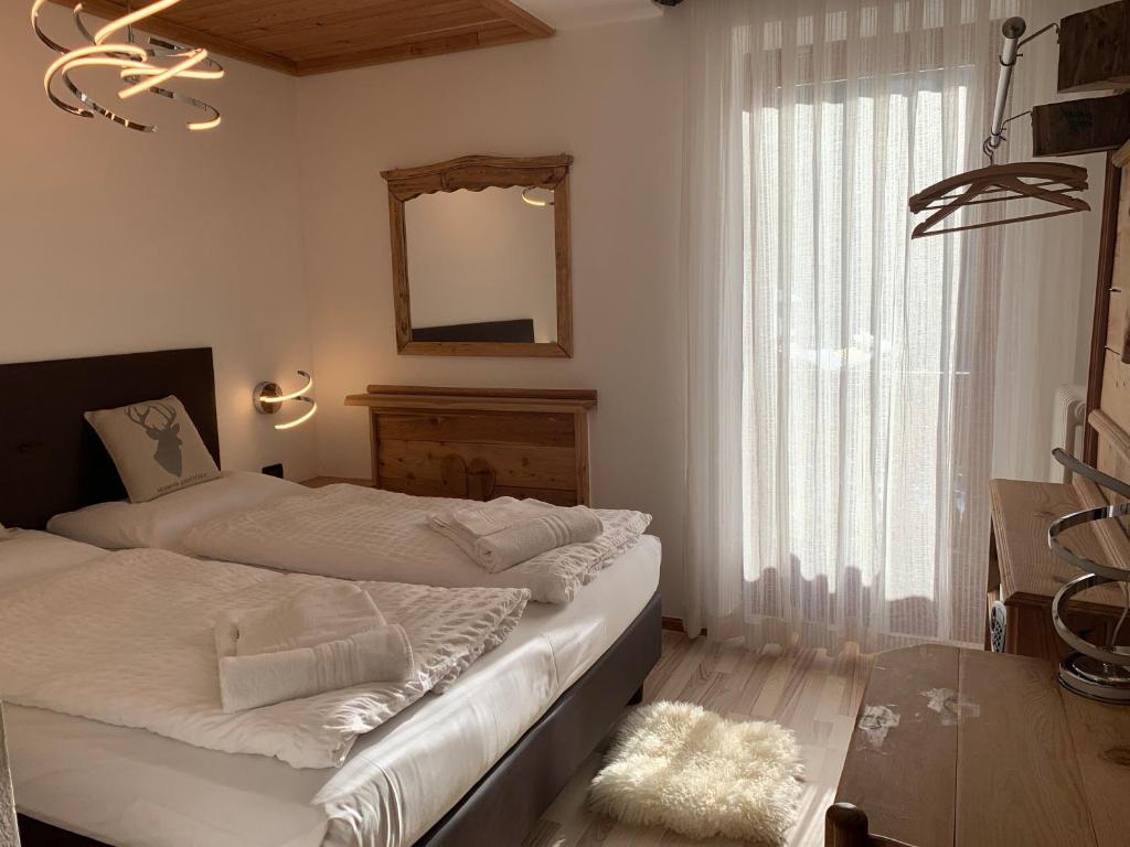 Postel nebo postele na pokoji v ubytování Hotel Pezzotti