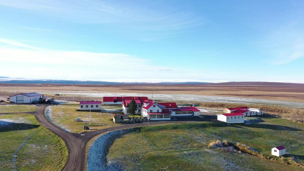 an aerial view of a farm with a dirt road at Guesthouse Stöng and Cottages in Stöng