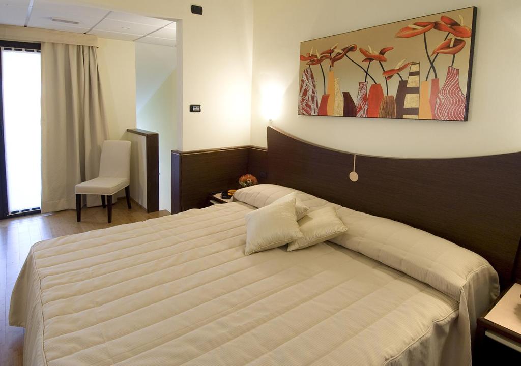 A bed or beds in a room at As Hotel Cambiago