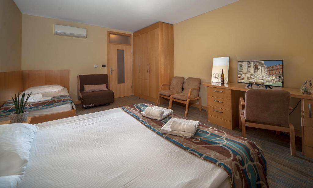 Postel nebo postele na pokoji v ubytování Hotel Malovec