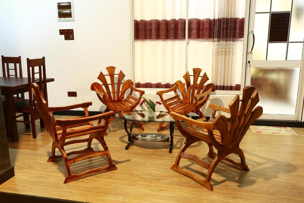 a group of chairs and a table in a room at Dearly Holiday Home And Safari in Tissamaharama