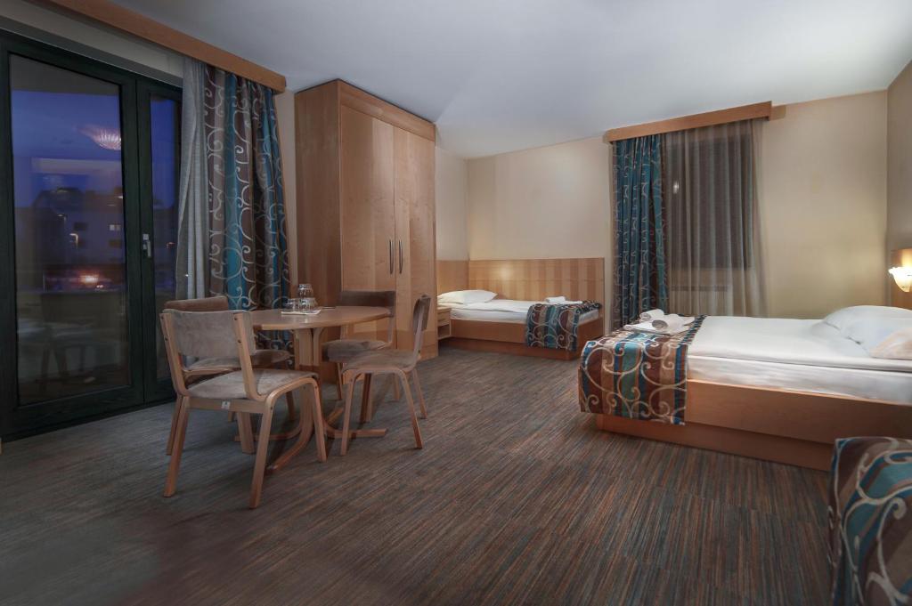 Postel nebo postele na pokoji v ubytování Hotel Malovec