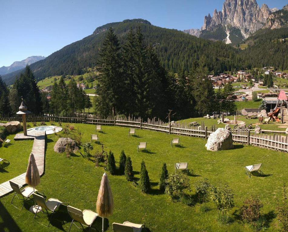a view of a park with mountains in the background at Agritur Agua Biencia in Pozza di Fassa