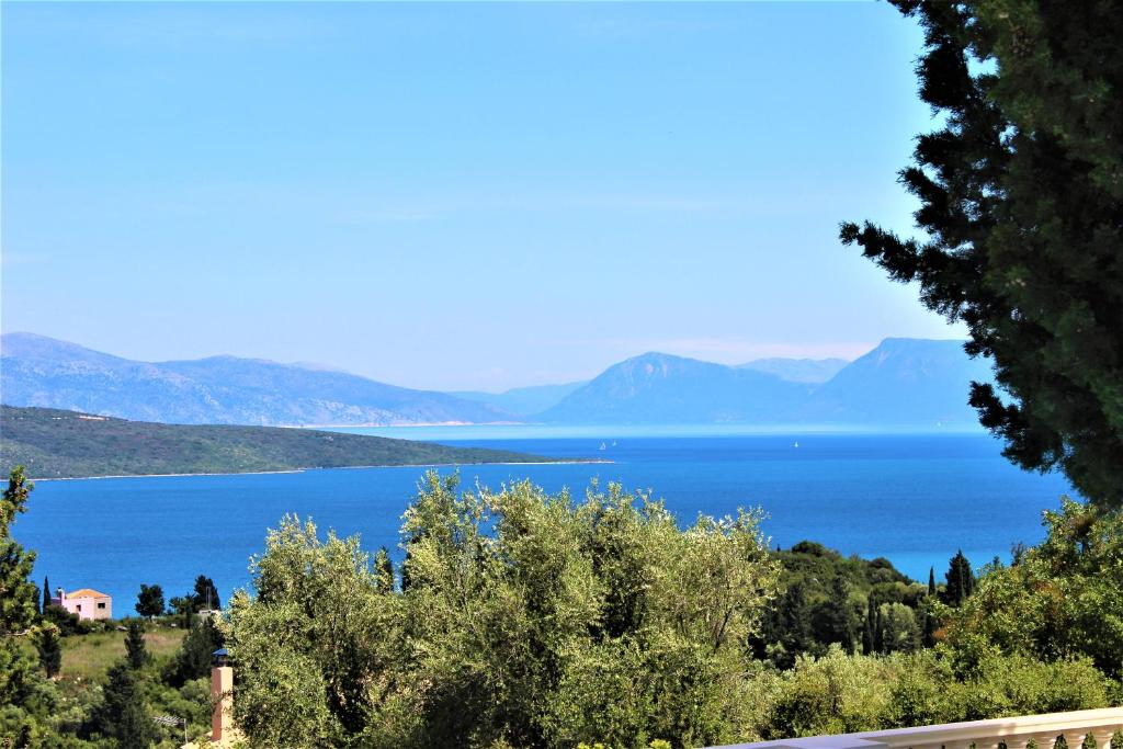 a view of a lake with mountains in the distance at Oliviero Villas in Lygia
