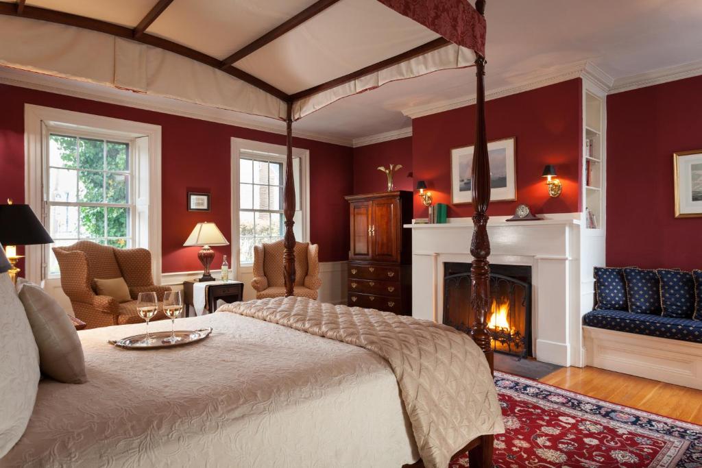 a bedroom with a bed and a fireplace at Harbor Light Inn in Marblehead