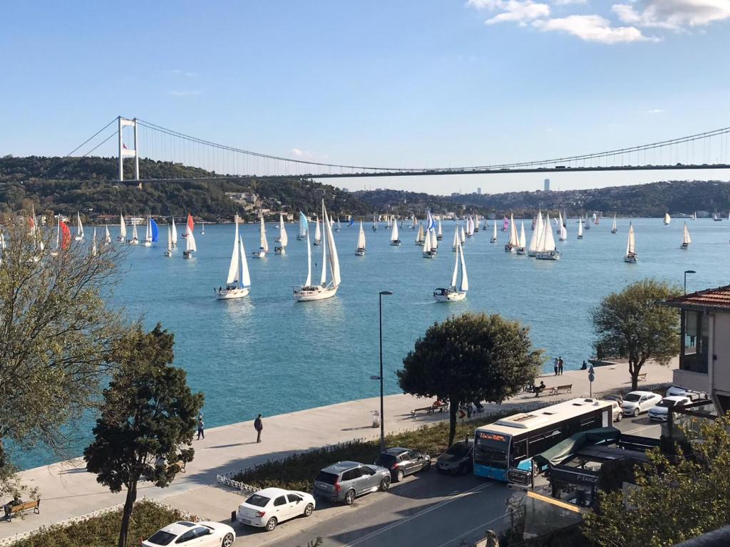 a bunch of sail boats in the water with a bridge at Emirganlı Suites in Istanbul