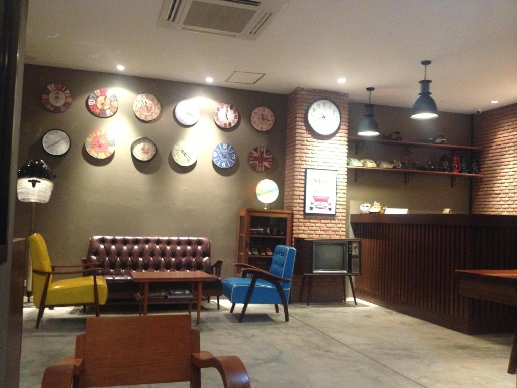 a restaurant with chairs and plates on the wall at Dfeel House in Patong Beach