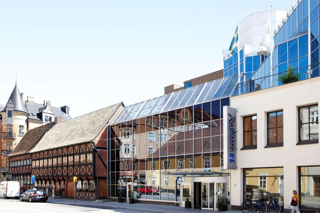 a building with a glass facade on a city street at Radisson Blu Hotel Malmö in Malmö